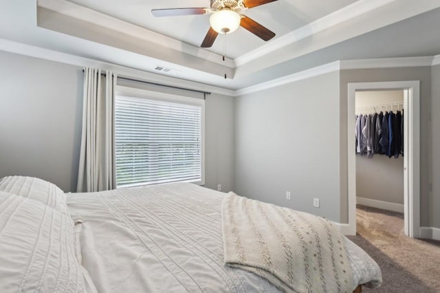 bedroom with visible vents, carpet floors, a raised ceiling, a closet, and a spacious closet