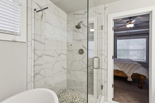 ensuite bathroom featuring connected bathroom, ceiling fan, a stall shower, and a freestanding tub