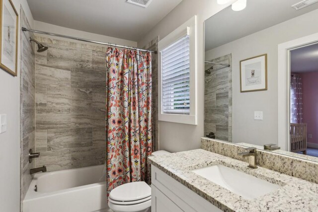 full bathroom with toilet, visible vents, shower / bath combo, and vanity