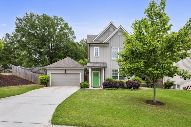 view of front facade with fence, board and batten siding, an attached garage, and a front yard
