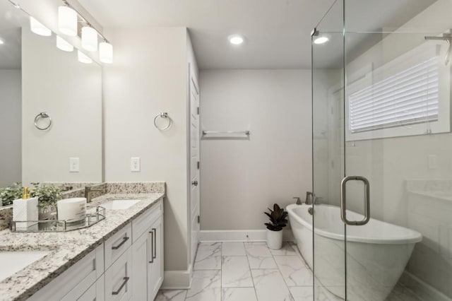 bathroom with a sink, double vanity, marble finish floor, recessed lighting, and a freestanding tub