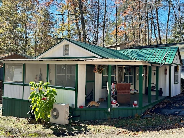 rear view of property with ac unit