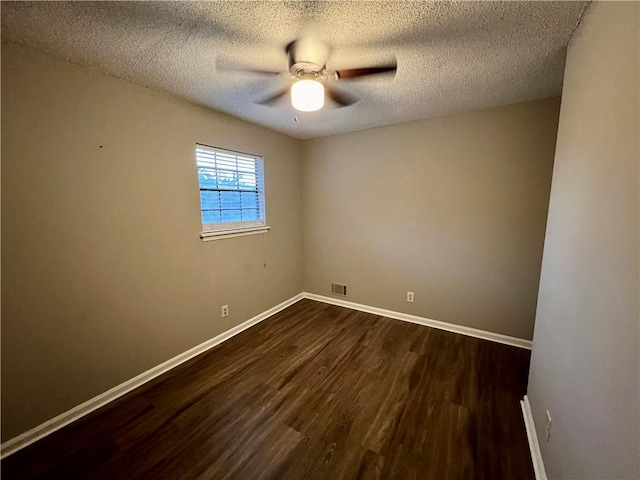 empty room featuring a textured ceiling, ceiling fan, and dark hardwood / wood-style flooring