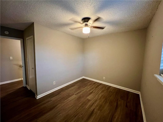 empty room with dark wood-type flooring, a textured ceiling, and ceiling fan