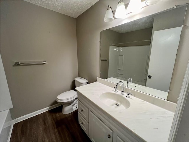 full bathroom featuring toilet, shower / bathtub combination, hardwood / wood-style floors, vanity, and a textured ceiling