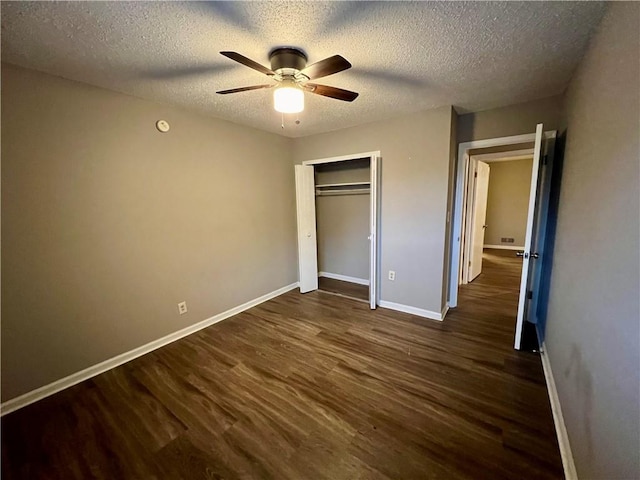 unfurnished bedroom featuring a closet, ceiling fan, a textured ceiling, and dark hardwood / wood-style floors