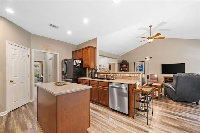 3633 Gilpin Ct, Lawrenceville, GA 30044 - kitchen with appliances with stainless steel finishes, a sink, light countertops, open floor plan, and lofted ceiling