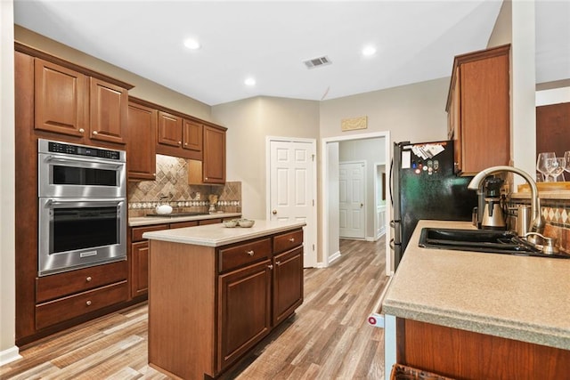 3633 Gilpin Ct, Lawrenceville, GA 30044 - kitchen featuring double oven, a sink, backsplash, light wood-type flooring, and recessed lighting