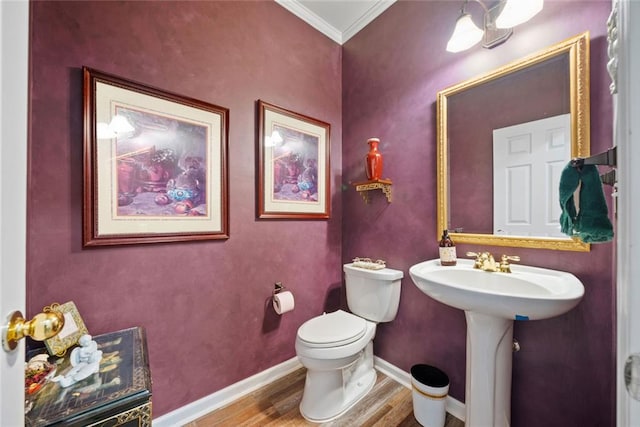 3633 Gilpin Ct, Lawrenceville, GA 30044 - half bath featuring wood finished floors, crown molding, toilet, and baseboards