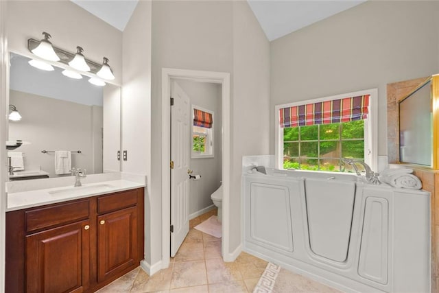 3633 Gilpin Ct, Lawrenceville, GA 30044 - bathroom featuring vanity, vaulted ceiling, toilet, tile patterned flooring, and a garden tub