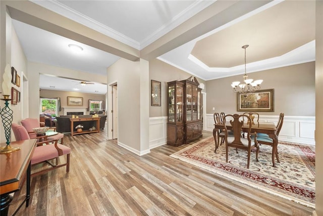 3633 Gilpin Ct, Lawrenceville, GA 30044 - dining room with wood finished floors, ornamental molding, wainscoting, a chandelier, and a ceiling fan