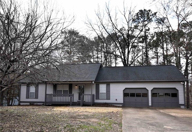 view of front of house featuring concrete driveway, a porch, an attached garage, and a shingled roof