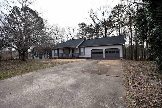 ranch-style house featuring driveway, a porch, and an attached garage