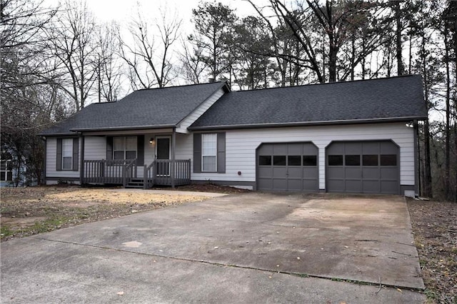 ranch-style home featuring a garage, covered porch, a shingled roof, and concrete driveway