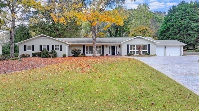 single story home with a garage, decorative driveway, and a front yard