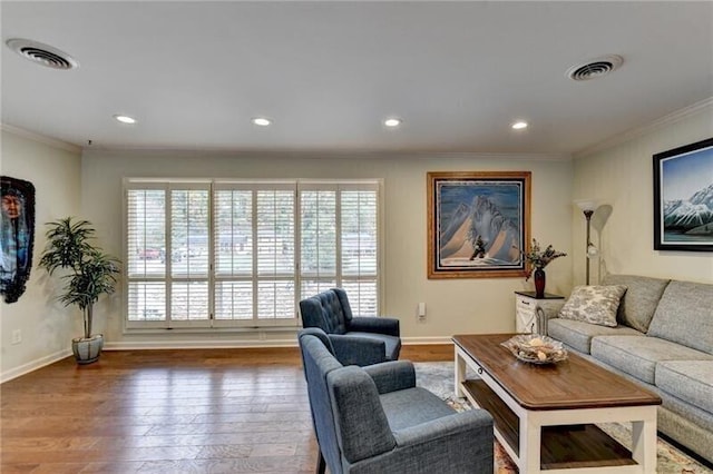 living area featuring wood-type flooring, visible vents, and plenty of natural light