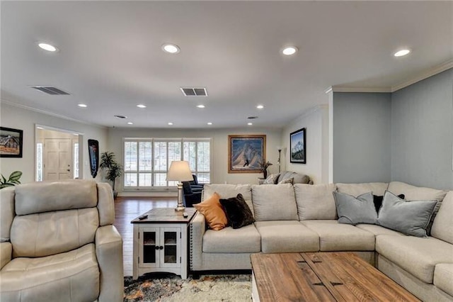 living area featuring light wood-style flooring, visible vents, and crown molding