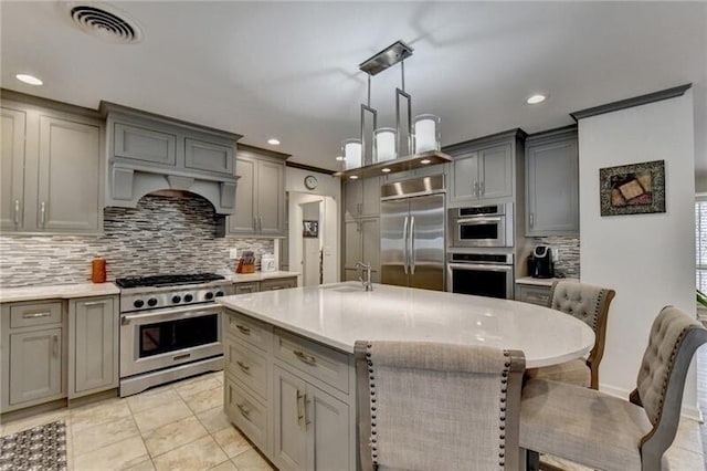 kitchen with stainless steel appliances, light countertops, visible vents, and gray cabinetry