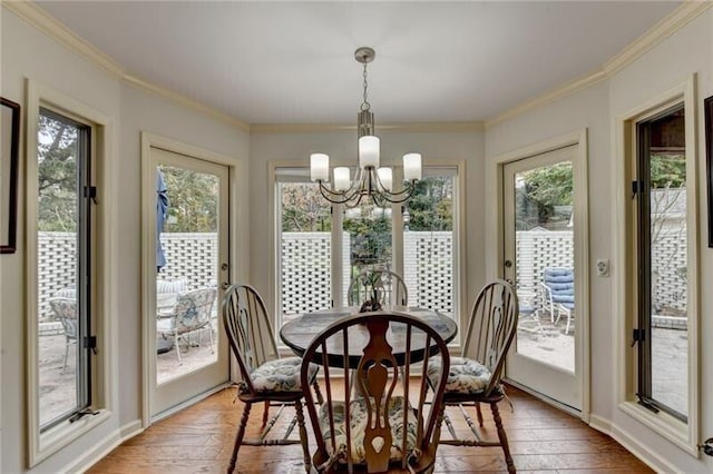 dining room featuring a chandelier, light wood finished floors, and ornamental molding