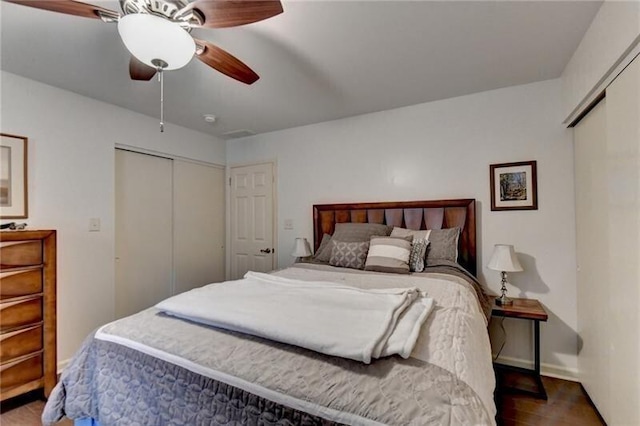 bedroom featuring a closet, wood finished floors, a ceiling fan, and baseboards