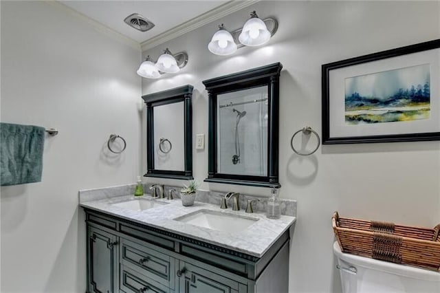 bathroom featuring crown molding, visible vents, a sink, and double vanity