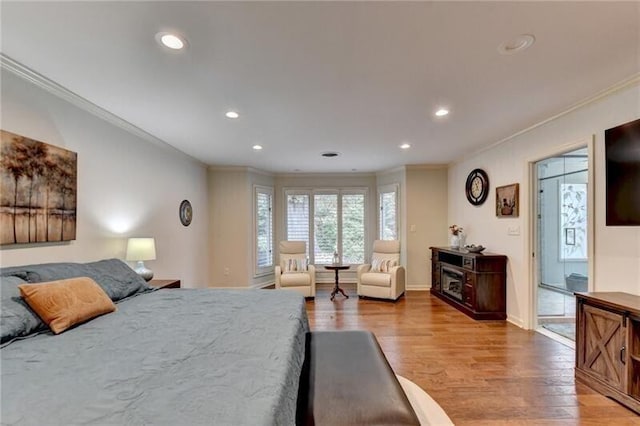 bedroom with recessed lighting, crown molding, and light wood-style flooring