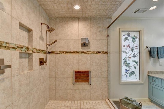 full bathroom featuring recessed lighting, visible vents, vanity, and tiled shower