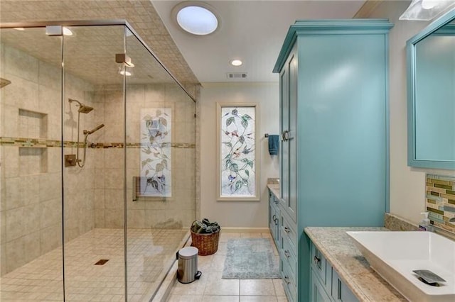 bathroom featuring a stall shower, tile patterned flooring, visible vents, and vanity