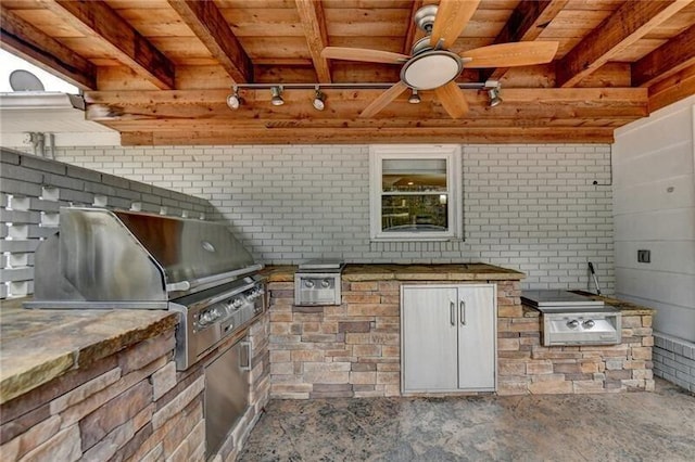 view of patio with exterior kitchen, area for grilling, and a ceiling fan