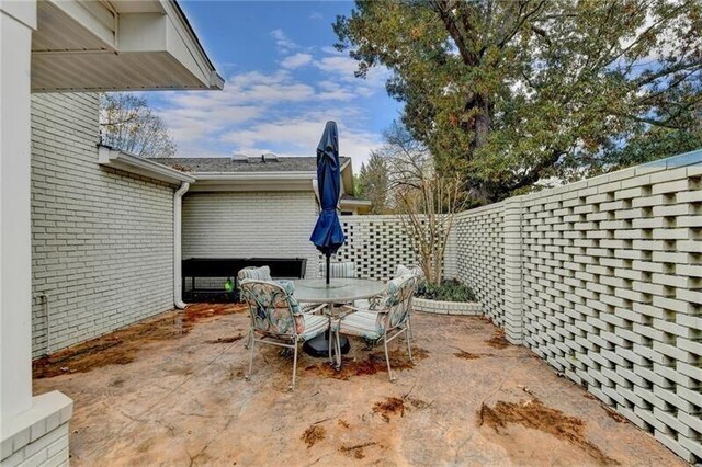 view of patio with outdoor dining area and a fenced backyard