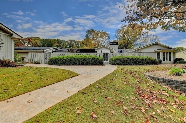 view of yard featuring a fenced front yard and a gate