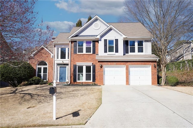 view of front facade with a garage, brick siding, and driveway