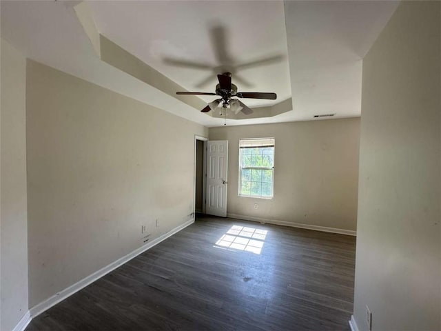 625 Mill Stone Blf Unit B, Monroe, GA 30655 - spare room featuring a raised ceiling, dark wood-type flooring, and ceiling fan