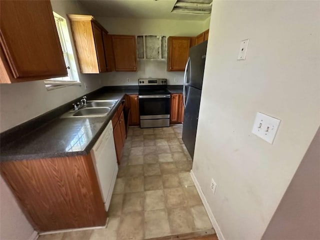 625 Mill Stone Blf Unit B, Monroe, GA 30655 - kitchen with electric range, white dishwasher, dark countertops, brown cabinets, and freestanding refrigerator