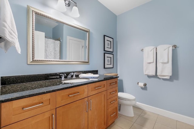 bathroom with vanity, tile patterned floors, and toilet