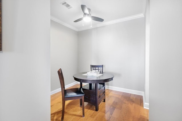 dining room featuring hardwood / wood-style flooring, ceiling fan, and ornamental molding