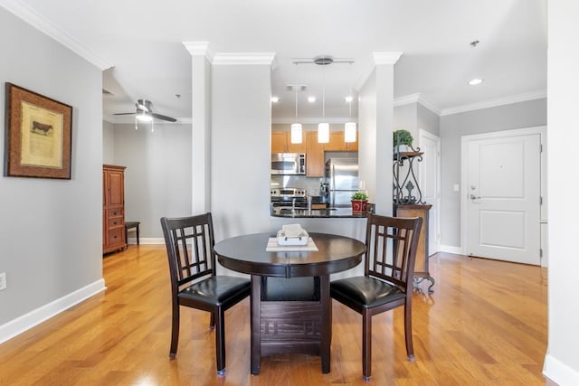 dining space featuring ornamental molding, light hardwood / wood-style floors, and ceiling fan