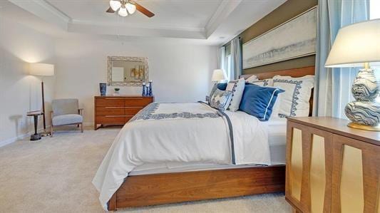 carpeted bedroom with ceiling fan and a raised ceiling