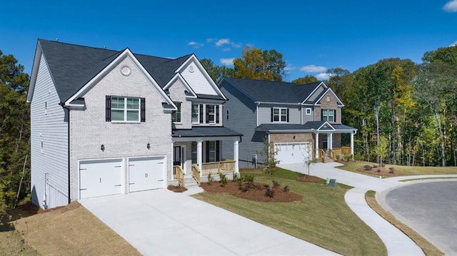 view of front of house featuring a front yard, a garage, and covered porch