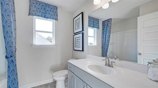 bathroom featuring vanity and toilet