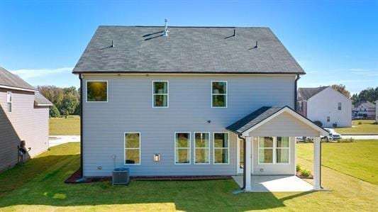 rear view of house with a yard and a patio area