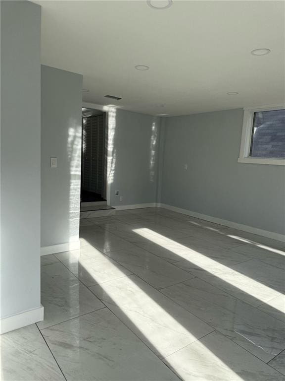 6774 Collier Rd, Riverdale, GA 30296 - spare room featuring baseboards and marble look tile flooring