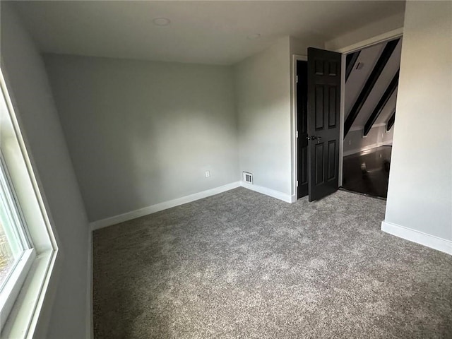 6774 Collier Rd, Riverdale, GA 30296 - unfurnished bedroom with baseboards and carpet floors