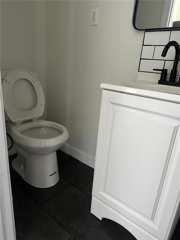 6774 Collier Rd, Riverdale, GA 30296 - bathroom with tile patterned flooring, vanity, toilet, and baseboards