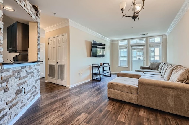 living room featuring crown molding, dark wood-type flooring, and a chandelier