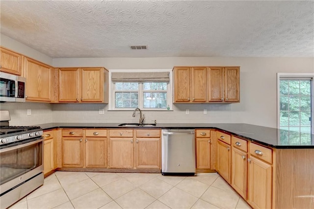 5229 Pine Branch Ct, Sugar Hill, GA 30518 - kitchen with appliances with stainless steel finishes, a sink, a peninsula, backsplash, and a textured ceiling