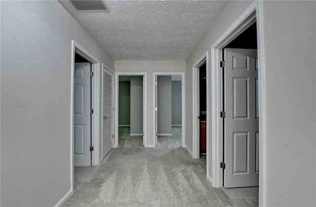 5229 Pine Branch Ct, Sugar Hill, GA 30518 - corridor featuring a textured ceiling, light carpet, and baseboards