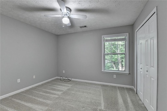 5229 Pine Branch Ct, Sugar Hill, GA 30518 - unfurnished bedroom with a closet, a textured ceiling, baseboards, carpet flooring, and a ceiling fan
