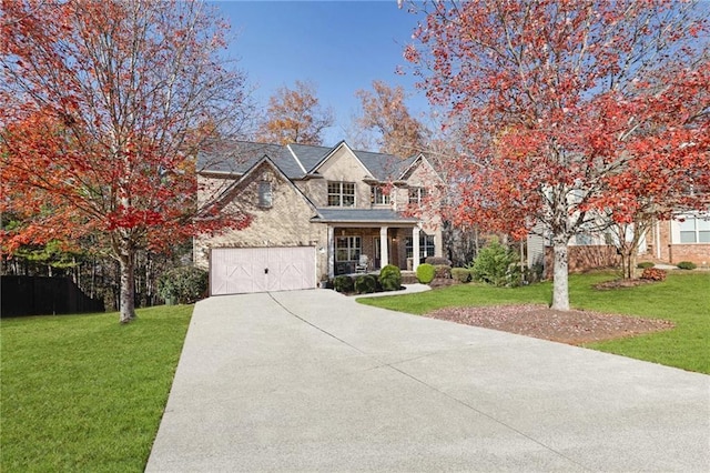 view of front facade featuring a porch, a garage, and a front lawn