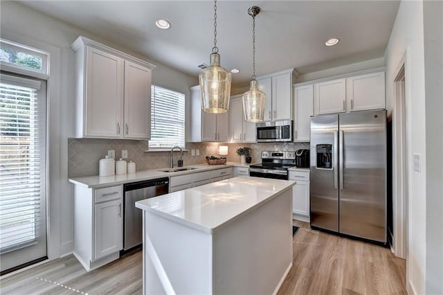 kitchen featuring a healthy amount of sunlight, appliances with stainless steel finishes, and white cabinets